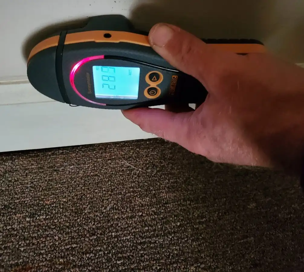 Moisture detection at baseboard during Storm Damage Restoration in Revere